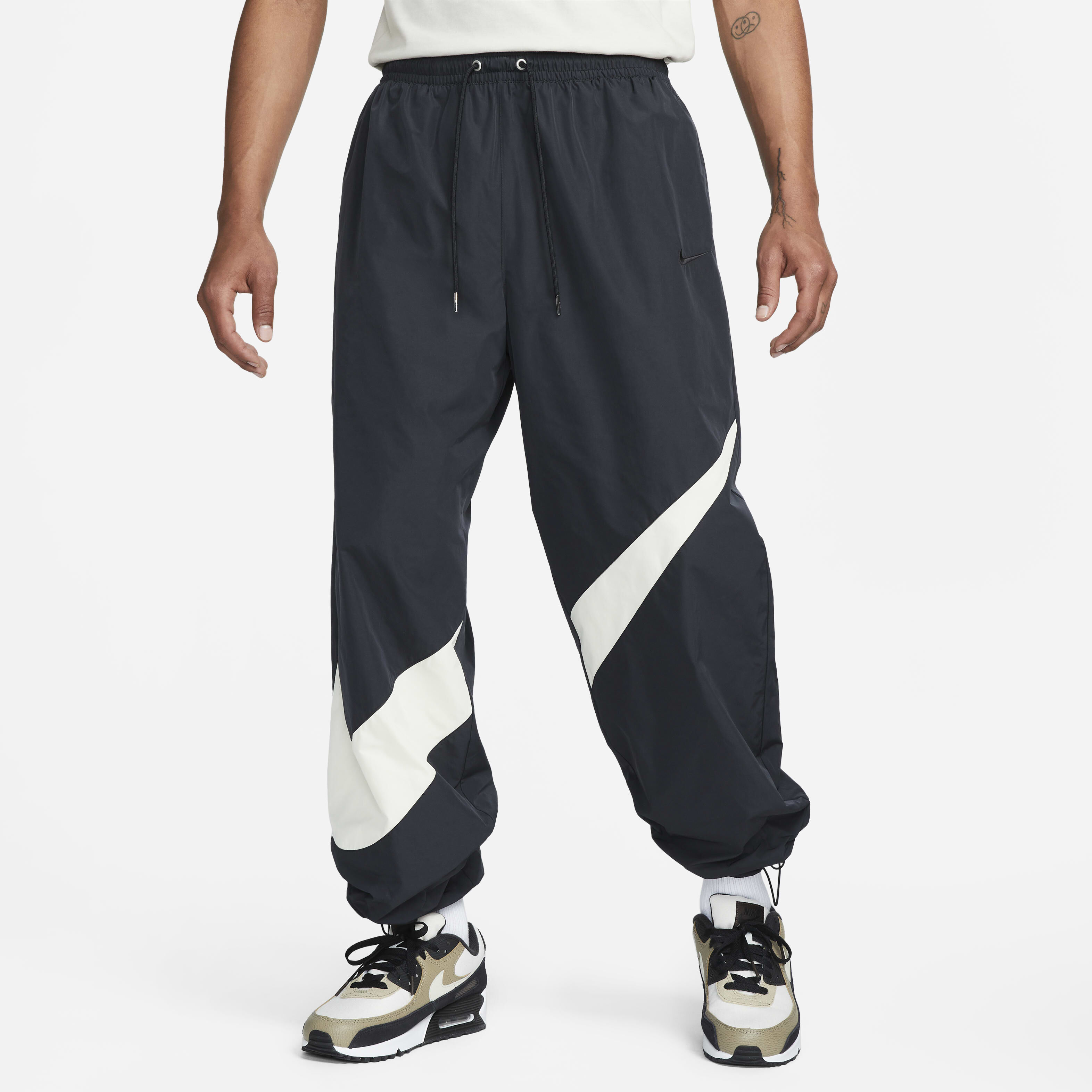 Buy Nike Swoosh Men s Woven Trousers Black Coconut Milk Black Nike Saudi Official