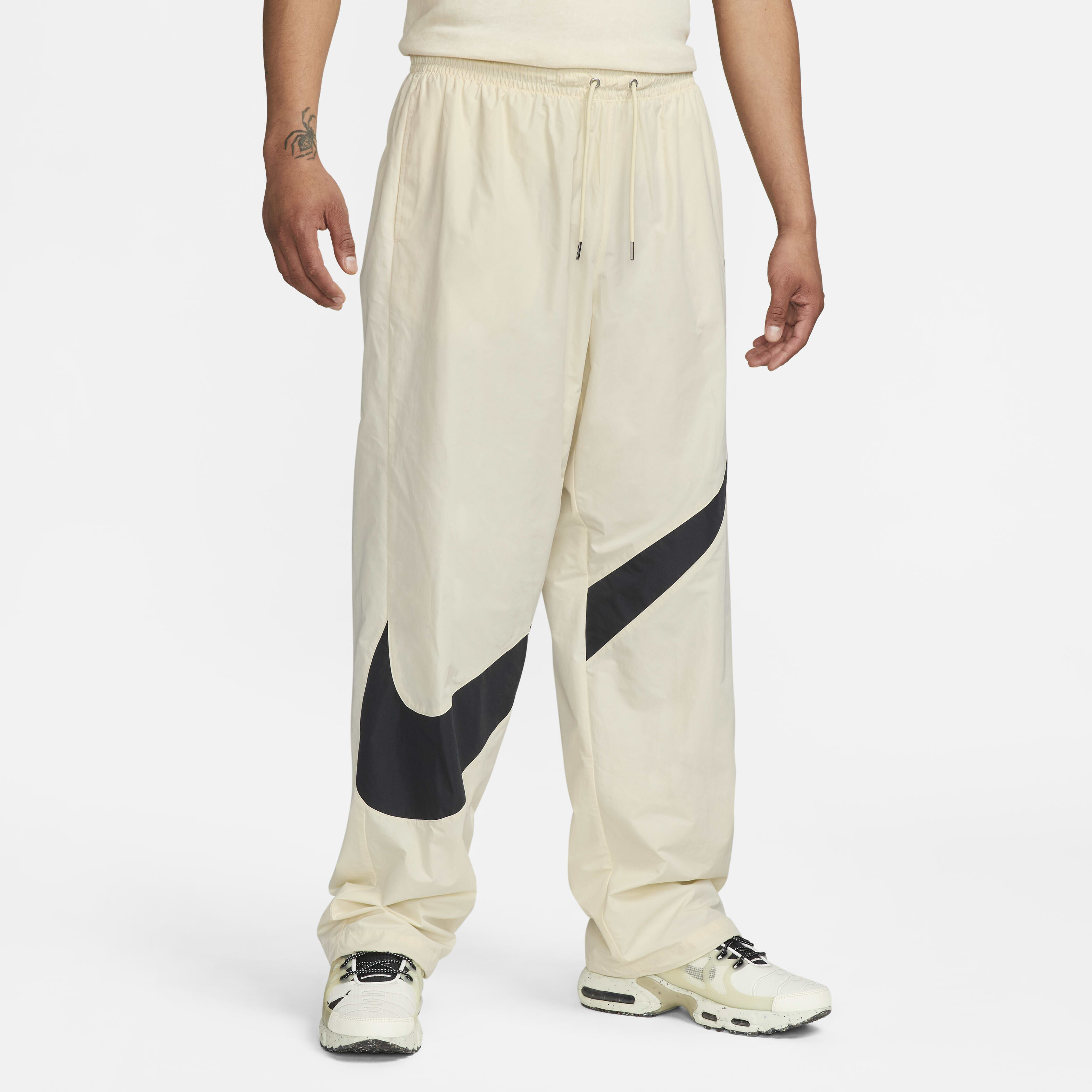 Buy Nike Swoosh Men s Woven Trousers Coconut Milk Black Coconut Milk Nike Saudi Official