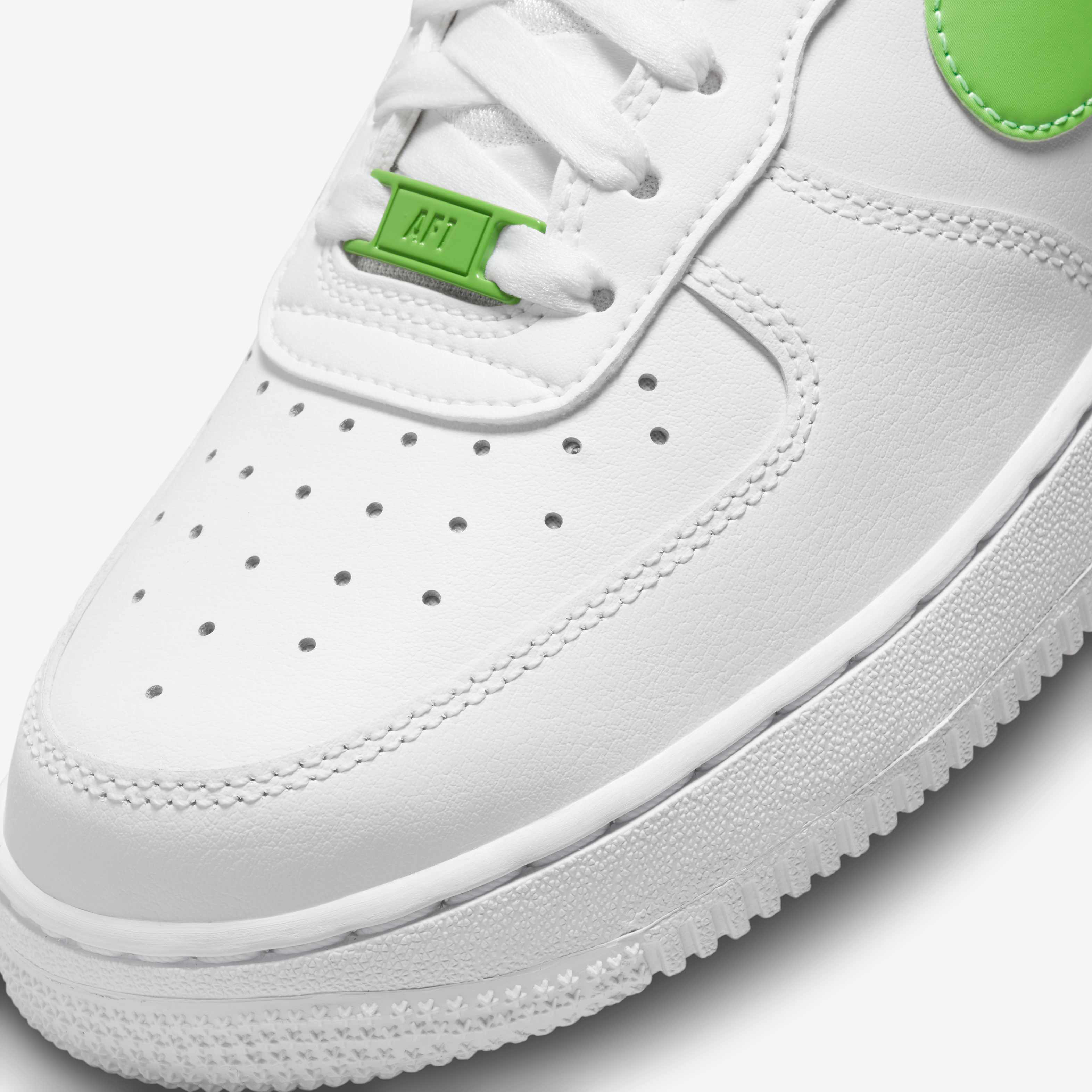white nike shoes with green tick