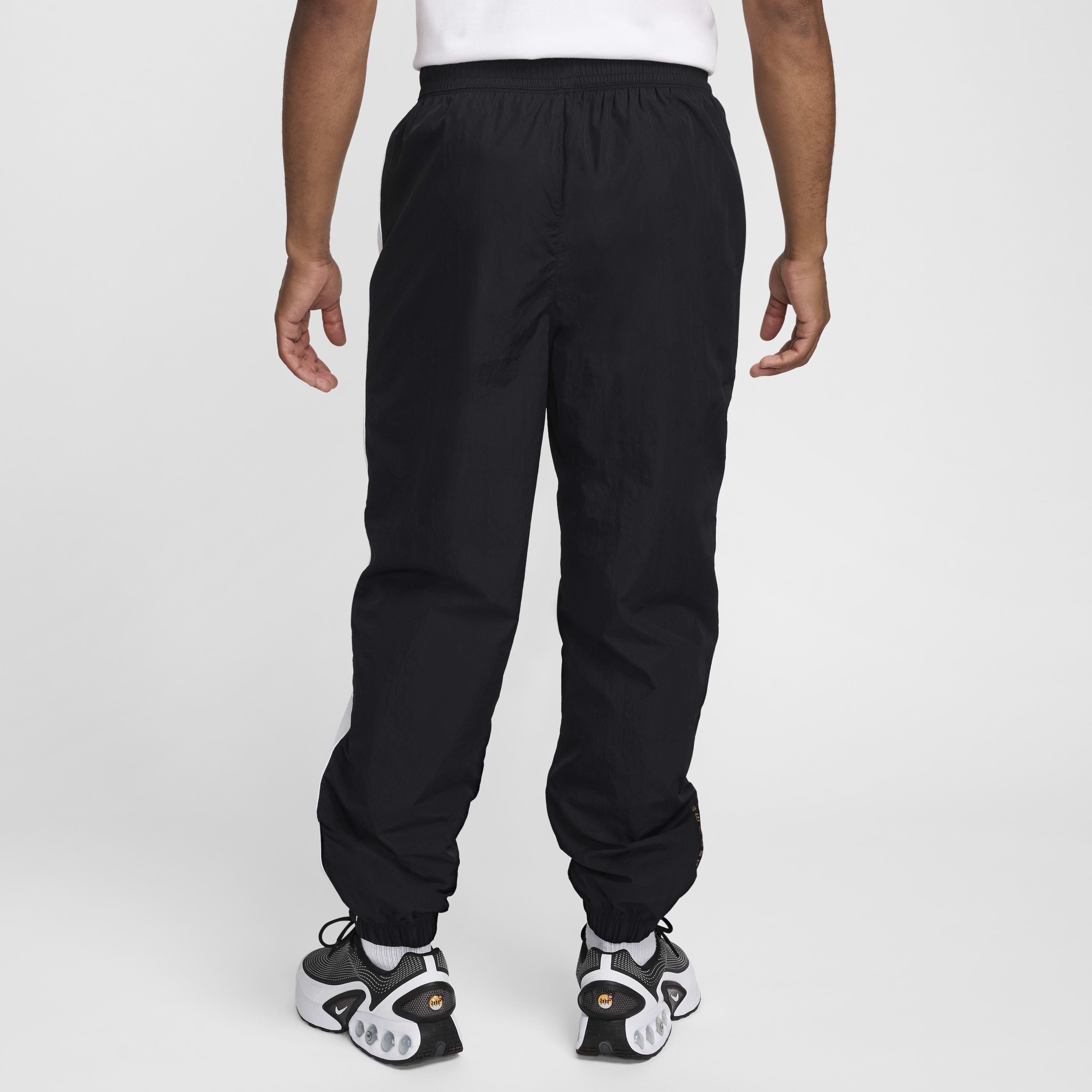 Buy Nike Air Men s Woven Trousers Black White Metallic Gold Nike Saudi Official